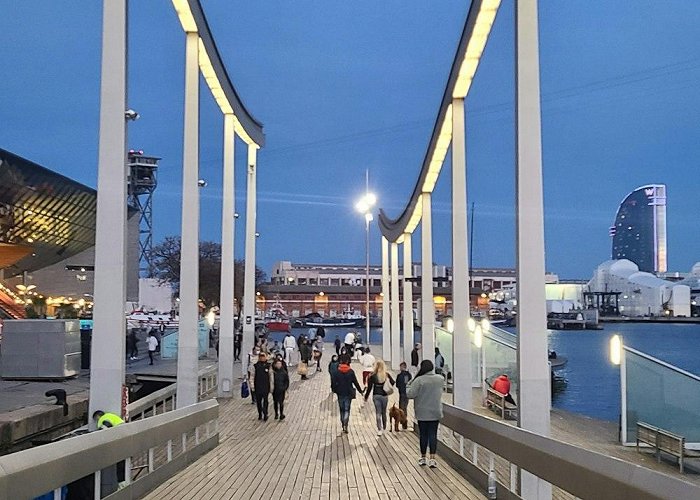 Maremagnum A group of people walking across a wooden bridge photo – Free ... photo